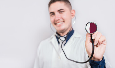 Doctor showing stethoscope with Qatar flag. Qatar national healthcare concept