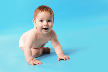Cute little baby crawling on light blue background