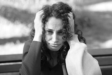 Portrait of homeless woman outdoors. Black and white effect