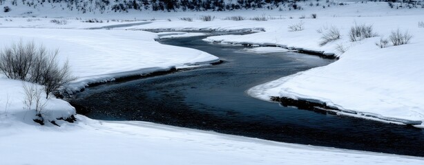 Winter river winding through snow