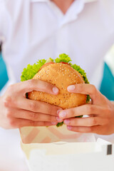 Burger hold on human hand. It is a high quality image