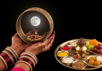 Karwa Chauth Celebration Woman s Hands Holding Traditional Thali with Moon Reflection and Diya