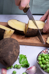 Cutting potatoes and other vegetables for cooking.
