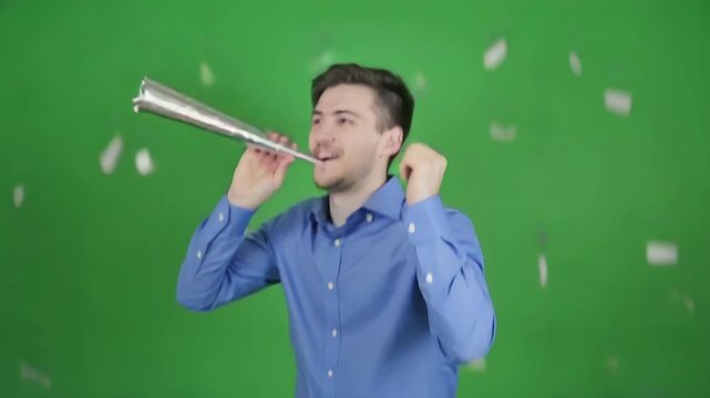 Excited Man Celebrating Success with Confetti Blast and Party Horn on Green Screen