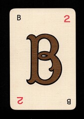 A decorative playing card featuring a letter from the English alphabet isolated on a black background.