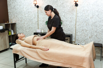 Gentle abdominal massage for a spa client, health body care concept.