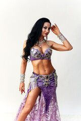 Elegant Brunette Dancer in Traditional Eastern Dance Costume Showcasing Grace.