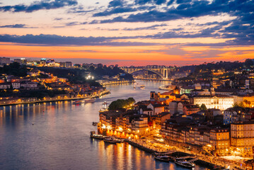 Illuminated Arrabida Bridge and Douro River in Porto at Sunset with City Lights, Portugal