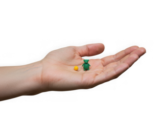 Miniature figures in an open human palm on transparent background