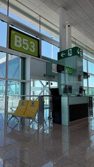 Barcelona, Spain - July 15, 2025: Airport terminal gate B53 with modern design, bright lighting, and seating area for travelers waiting to board flights