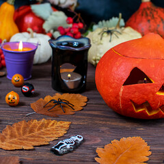 Carved pumpkin with candles and festive decor for Halloween celebration