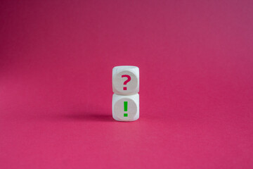 Question mark and exclamation mark symbol. Question mark and exclamation mark on wooden cubes....