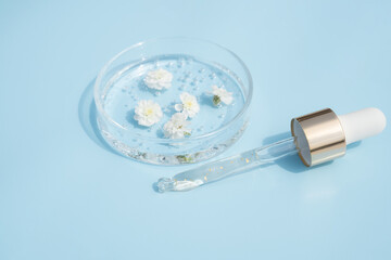 Dropper glass branding mockup. Cosmetic pipette. Trendy blue background. Concept of organic and...