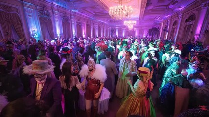 Large group of people in masquerade costumes at a party