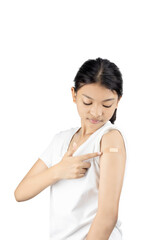 Young Asian woman points to a bandage on her arm after a vaccine injection. Healthcare and immunization concept isolated on white background with clipping path.