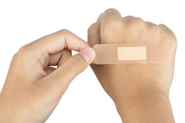 Applying an adhesive bandage to a hand for first aid. Wound care for a cut or injury concept,...