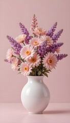 Beautiful Pink and Purple Flowers in a White Vase Against a Pink Background.A bouquet of delicate pink gerbera daisies and purple flowers, likely hydrangeas, arranged in a smooth, round white vase.