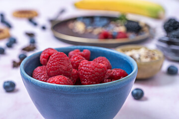 Blueberry and avocado brunch smoothie bowl, served in a blue ceramic bowl with a wooden spoon and a rustic background