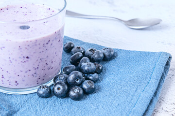 Blueberry and red wine smoothie (healthy sangria), garnished with herbs and thinly sliced fruit