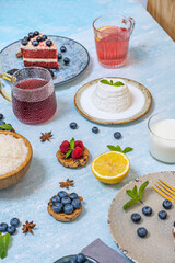 Delicious fresh blueberries alongside vibrant red berry juice, a feast of color and natural antioxidants