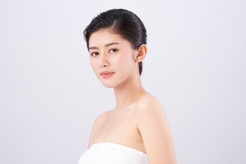 A beautiful young Asian woman with clean, fresh skin against a white background. Skincare, facial...