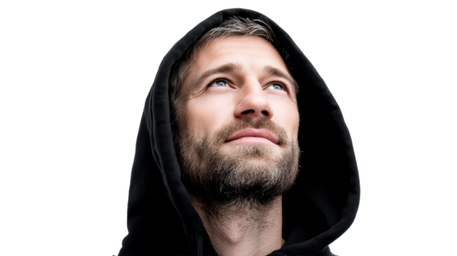Man in hoodie looking upward with a thoughtful expression
