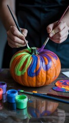 halloween craft ideas Colorful pumpkin painting in progress, showcasing creative artistic expression.