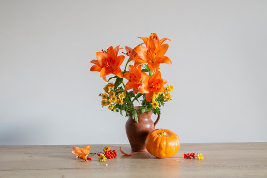 orange flowers and autumn decorations   on wooden table