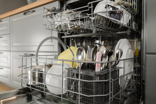 Clean dishes and cutlery inside dishwasher