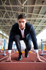 Businessman sprinting on track: leadership and determination concept