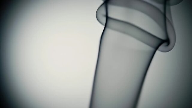 Ethereal Dark Gray Smoke Streams Against Soft White Gradient Backdrop