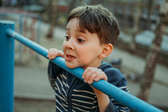 Boy climbing monkey bars at park