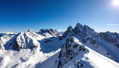 Panoramic view of snow-covered mountain peaks under a vibrant blue sky (1)