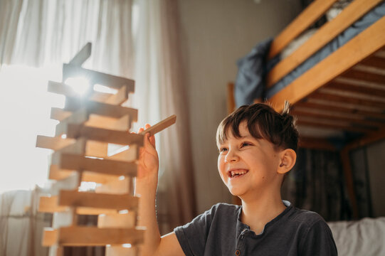 Happy boy playing block removal game at home