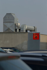 A prominent red exit sign is displayed, featuring an arrow that clearly points to the right,...