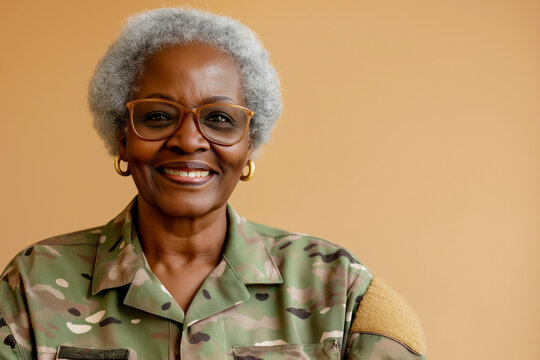 Cheerful African-American female military veteran with beige backdrop