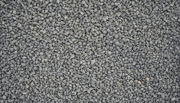 Close-up top view of dark gray crushed stone gravel. Abstract texture background of small sharp rocks for construction or landscaping design.