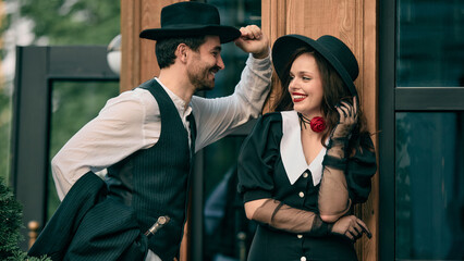 Man tipping hat while smiling at woman in retro outfit. Concept of romantic novella cover, cultural...
