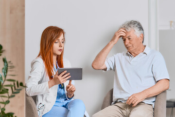 Concerned doctor discussing healthcare options with an older man patient during a professional consultation in a clinic. 