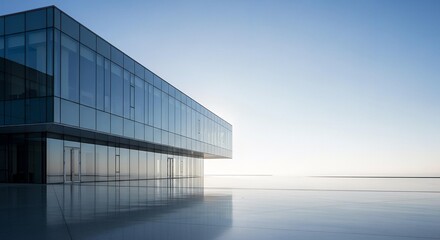 Modern glass building reflecting the sky on a wet surface