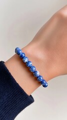 Blue Bead Bracelet Elegance: A wrist adorned with a delicate blue bead bracelet showcases refined grace and understated glamour. Each bead mirrors the beauty of ocean.