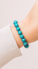 Turquoise Beaded Bracelet on Wrist: A person's wrist adorned with a beautiful turquoise beaded bracelet, perfectly capturing the elegance and vibrant style.