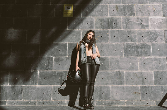 Portrait of sexy young woman posing with motorcycle helmet