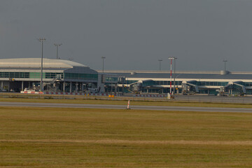 A busy airport runway featuring a large building in the background, emphasizing the essential role...