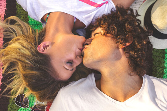 Young couple kissing on blanket