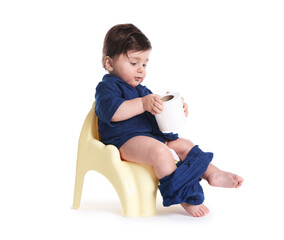 Cute little baby sitting on potty with toilet paper against white background
