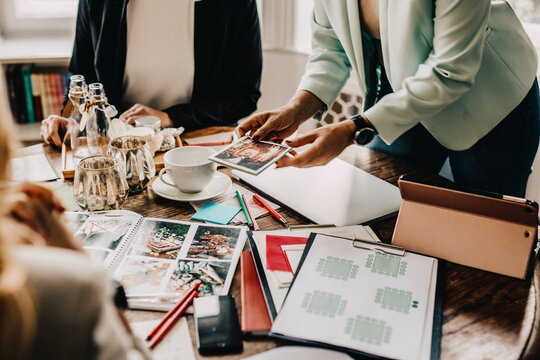 Female event planners explaining to customer during meeting