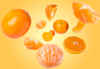 Juicy tangerines swirling in air against orange gradient background