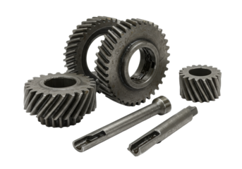 Five worn industrial metal gears (large spur, helical, three pinions) with aged steel finish and grease, perfectly lit on a transparent background, ultra-realistic product display of mechanical