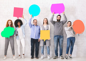 Sharing ideas. Group of diverse friends holding blank colorful speech bubbles with empty space